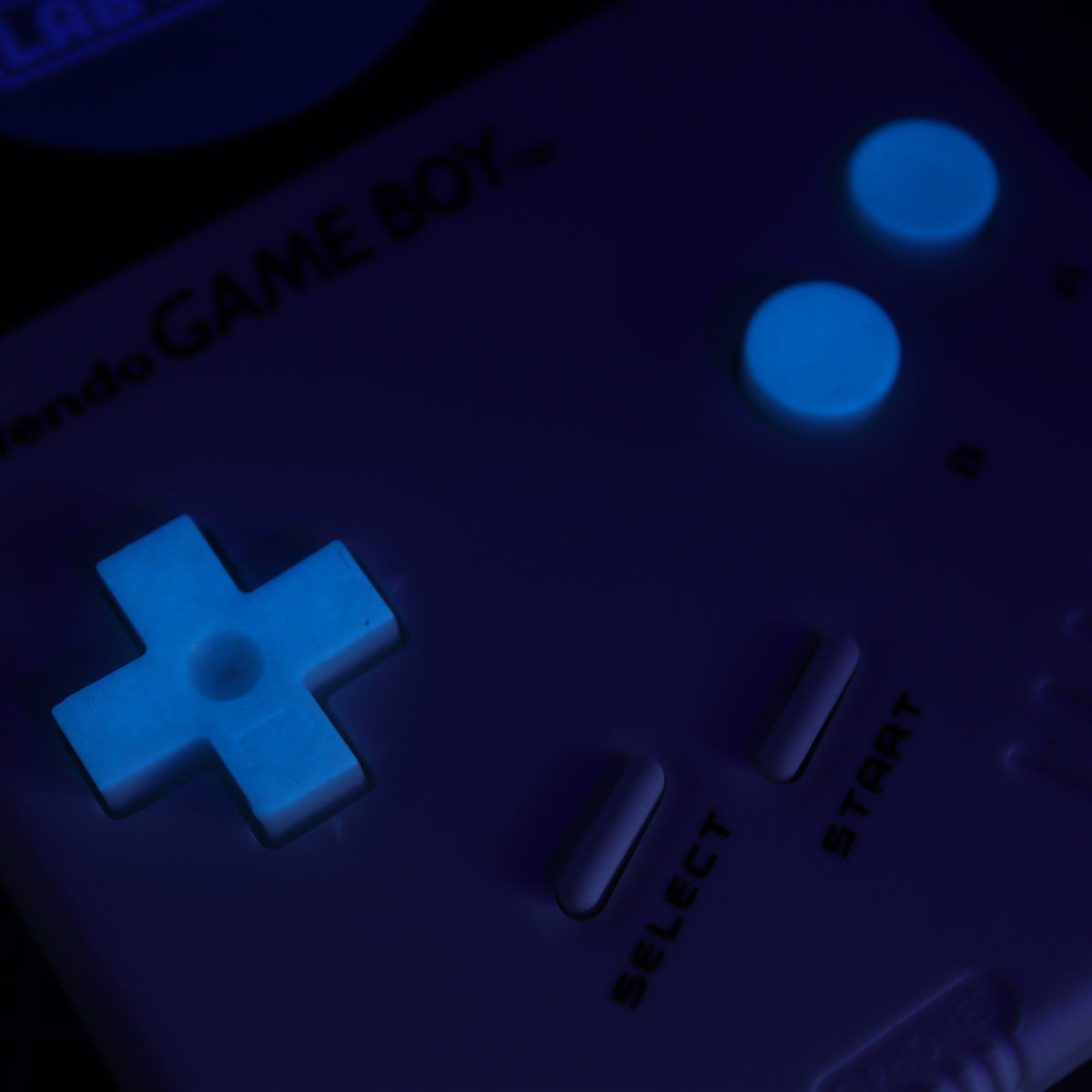 Hand cast custom resin buttons for Nintendo NES controller NES-004 (also fits Game Boy DMG-01) - Glow in the Dark Blue | Lab Fifteen Co