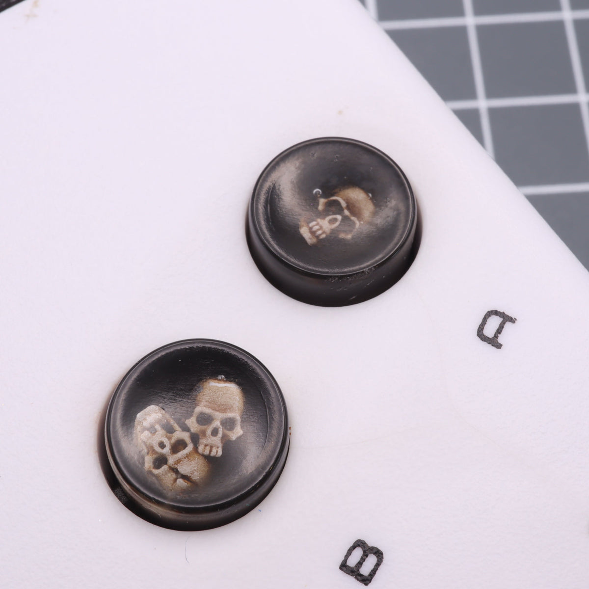 Hand cast custom resin buttons for Nintendo NES controller NES-004 (also fits Game Boy DMG-01) - Skull | Lab Fifteen Co